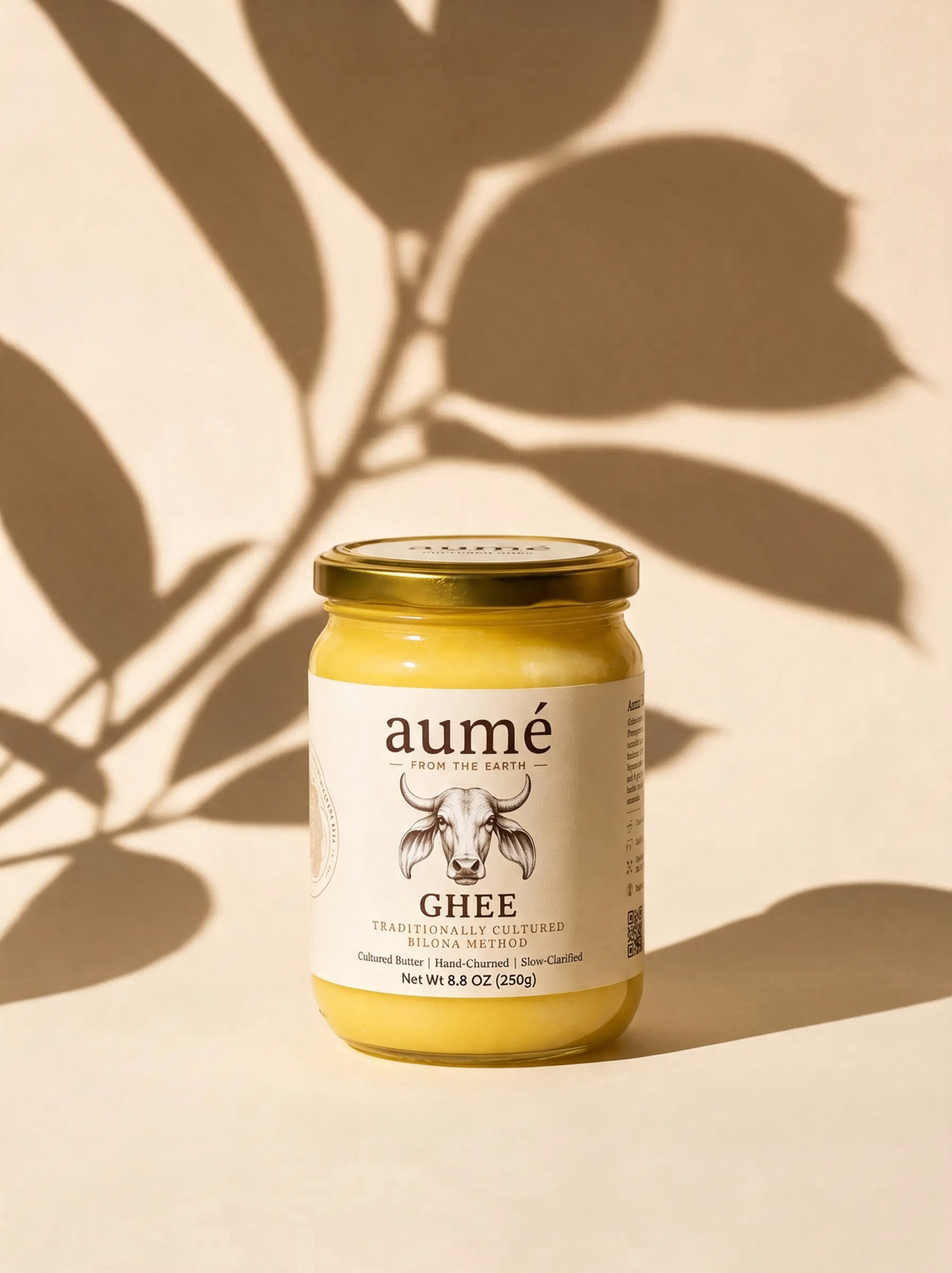 Aumé A2 Gir cow bilona ghee 250g jar, hand-churned, with leaf shadows